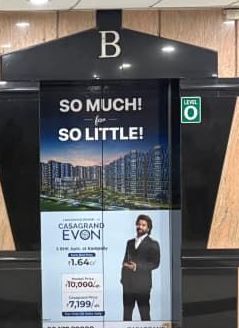 Casagrand ad branding on a lift door in a tech park lobby